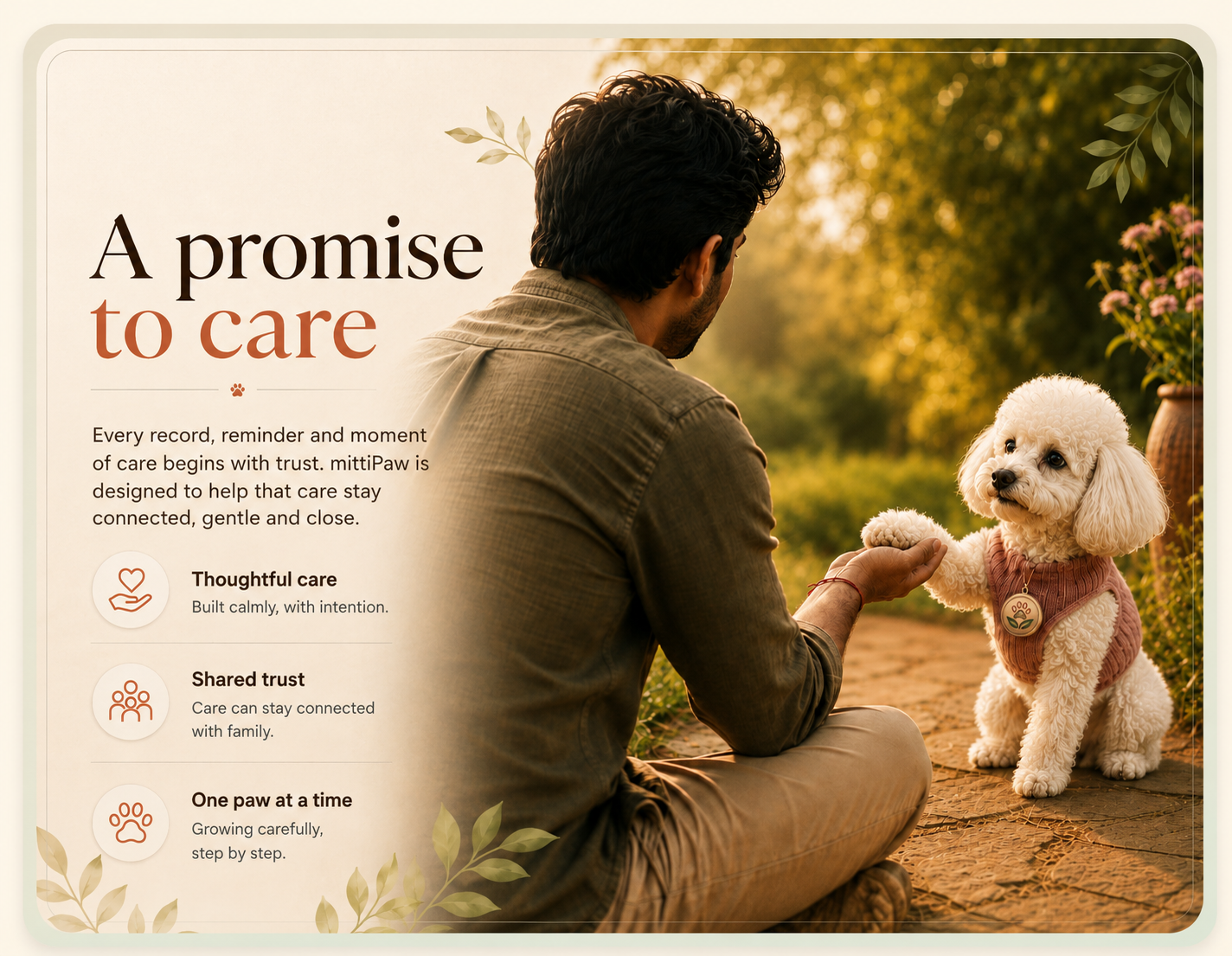 A white toy poodle gently places a paw into a pet parent's open hand in a sunlit garden.